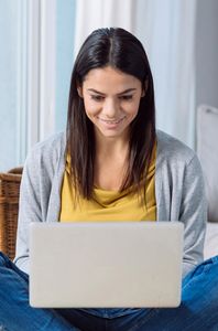 smiling woman using laptop
